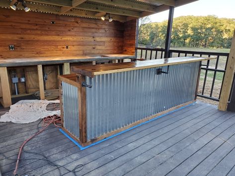 I took old rotting barn wood from my horse stables and power washed it, ripped it down, cut it into planks and built this bar with some roofing from Lowes. Industrial Outdoor Bar, Galvanized Bar Ideas, Pole Barn Bar, Outdoor Bar Diy Galvanized Metal, Barn Bar Ideas, Corrugated Metal Bar, Outdoor Bar With Corrugated Metal, Green Corrugated Metal, Tin Siding