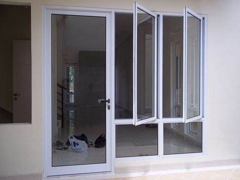 Pemilihan pintu kaca UPVC bukanlah tanpa alasan. Ketahanan dan warna yang elegan menjadi keunggulannya sehingga membuat material ini makin banyak di pilih di bandingkan yang lainnya. Jika dahulu banyak orang yang memilih kayu karena persediaannya masih terjaga, saat ini, banyak yang mulai beralih ke material lain. Apalagi untuk rumah-rumah atau bangunan dengan gaya minimalis, maka pintu kaca ini akan semakin #kacaUPVC #Pintukaca #tipsbelipintukaca Folding Patio Doors, House Window Design, Aluminium Windows And Doors, Home Door Design, Latest House Designs, Kitchen Design Plans, Minimalist House Design, House Doors, Kitchen Room Design