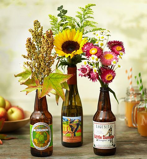 Turn Vacation Souvenirs Into Home Decor | Julie's Lifestyle Blog Flower In Beer Bottle, Oktoberfest Floral Arrangements, Beer Bottle Flower Vase, Flowers In Beer Bottles, Beer Flower Arrangement, Beer Bottle Flower Arrangements, Octoberfest Centerpieces, Beer Bottle Decoration Ideas, Bottle Vases With Flowers