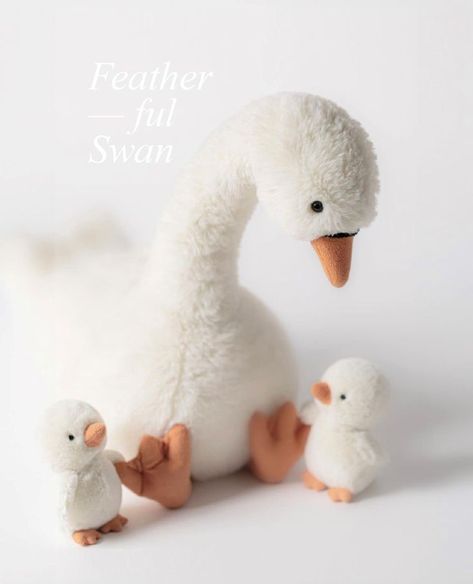 This is the Featherful Swan by Jellycat.

Mummy swan comes with the softest white vanilla fur, with matching fluffy wings, a long neck and orange suede feet with a matching beak. Featuring two little babies tucked in the back, that can pop out by themselves to go for a paddle in the pond. This iconic mummy and baby duo are too cute for words. A lovely addition to any plush collection. Swan Plush, Jellycat Toys, Plush Collection, Long Neck, The Pond, Spring Easter, Pop Out, Easter Spring, Plush Toy