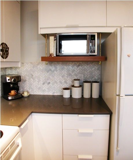 I LOVE the way this microwave is mounted! I don't know how this will work for my microwave because I think it is 15-18" deep. Microwave Cabinet, Microwave Shelf, Grey Countertops, Microwave In Kitchen, Eclectic Kitchen, White Cabinetry, Tiny Kitchen, Updated Kitchen, White Cabinets