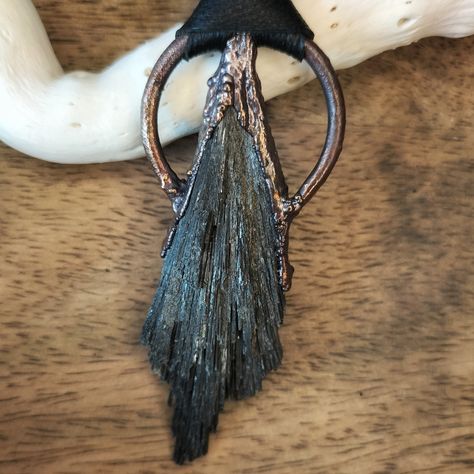 Step into the realm of magic with our Black Kyanite Witch Broom Talisman, beautifully set in a circle of copper. This talisman is handcrafted to harness the protective and grounding energies of black kyanite, known as the witch's broom. The copper circle not only enhances the aesthetic appeal but also amplifies the stone's natural properties, making it a powerful tool for spiritual practices, meditation, or as a unique accessory. Black kyanite broom provides grounding and protective energy, ofte Kyanite Broom, Black Kyanite, Protective Energy, Soldered Jewelry, Soldering Jewelry, Witch Broom, Work Jewelry, Healing Jewelry, Metal Work