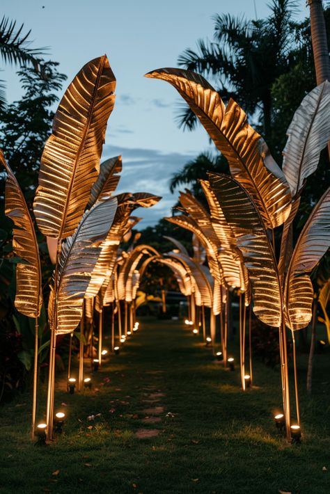 Make a Grand Entrance: Gilded Tropical Leaves & Candlelit Pathway Ideas  - Evening Wedding Ideas Indoor Tropical Wedding Ceremony, Elegant Tropical Party, Evening Wedding Ideas, Tropical Glam Decor, Tropical Gala, Glam Party Decor, Golden Wedding Decor, Island Wedding Ideas, Reception Venue Decorations