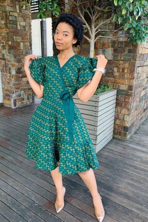 A lady wearing an Ankara wrap gown Ankara Wrap Gown Styles, Short Dress Styles For Women, Simple Short Ankara Gowns, Simple Ankara Dress Styles, Ankara Wrap Dress Styles, Wrap Ankara Dress, Wrap Gown Styles, Ankara Dress Styles For Ladies, Ankara Short Dress Styles