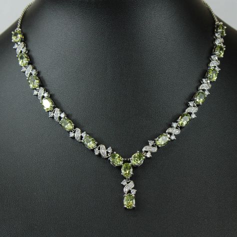 "WHITE GOLD FINISH Created Diamond Peridot \"Love and Kisses\" Necklace, Part of the Love and Kisses Collection This stunning green necklace is hand finished with beautiful peridot stones and created diamonds. It's a sophisticated touch to any look making you look elegant and graceful. Peridot, the bright green colour of nature, is associated with harmony, good health, restful sleep, and peacefulness. Known as the stone of compassion, peridot calms anger by giving renewal to all things. When set in gold, this gem was said to protect the wearer from nightmares. Beautifully designed to make a wonderful moment into a truly amazing moment and a special gift for that someone special. You are already beautiful; this piece will simply adorn your own inner beauty and reflect your decorated eleganc Peridot Jewelry Set, Peridot Jewelry Necklaces, Love And Kisses, Green Stone Jewelry, Queens Jewels, Peridot Birthstone, Love And, Peridot Jewelry, Peridot Necklace