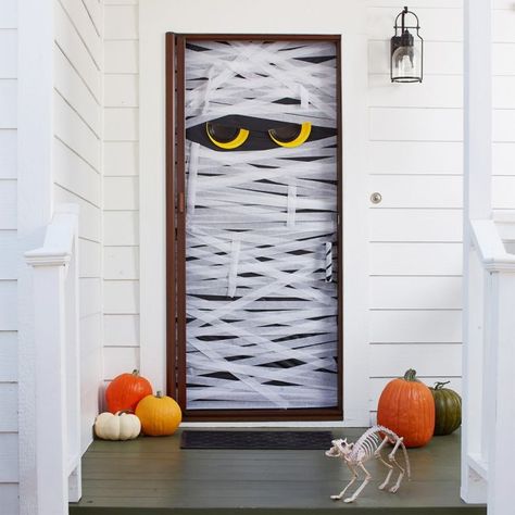 7 Halloween Door Decorating Ideas That Are Too Cute to Spook | Party City Mummy Door, Halloween Porch Lights, Porche Halloween, Halloween Decorations Outdoor Porch, Halloween Diy Door, College Halloween Party, Halloween Porch Sign, Dulces Halloween, Kid Friendly Halloween