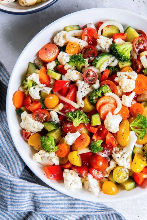 This vibrant Marinated Vegetable Salad is a great way to add a burst of color and fresh, healthy vegetables to your table. Cauliflower, broccoli, carrots, tomatoes, and more soak up the deliciously tangy, slightly sweet vinegar marinade. #salad #healthyrecipes #vegetables #eatyourveggies #sidedish Marinade Salad, Marinated Cauliflower, Marinated Vegetable Salad, Veggie Salads, Marinated Vegetables, Veggie Salad, Healthy Vegetables, Vegetable Salad, Vinegar