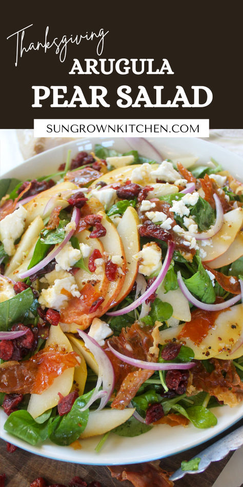 Perfect for the holidays or any time of year, this Pear Arugula Salad is an incredibly delicious combination of salty and sweet! Easy to make crispy prosciutto, sharp red onions and peppery arugula meet sweet pears, dried cranberries and a honey red wine vinaigrette for an elegant side dish, ready in 20 minutes! Pear And Arugula Salad, Arugula Pear Salad, Pear Arugula Salad, Roasted Pear Salad, Pear Salad Recipes, Crispy Prosciutto, Sweet Easy, Roasted Pear, Red Wine Vinaigrette