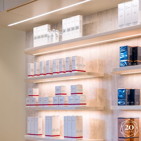 The natural material and neutral colour palette used for this wall display allows the lighting to truly show off the products on shelf. Clean and attention grabbing this sleek design is very minimal and non intrusive to prevent the space from becoming loud and overcluttered.  #DentalInteriors #DentalAesthetics #ReceptionDesign #DesignInspiration #FitOutCompanySydney #medical #fitoutsmelbourne #receptionfitout Medical Spa Product Display, Factory Office, Skincare Clinic, Waiting Room Design, Clinic Interior, Dermatology Clinic, Doctor Names, Office Shelving, Clinic Interior Design