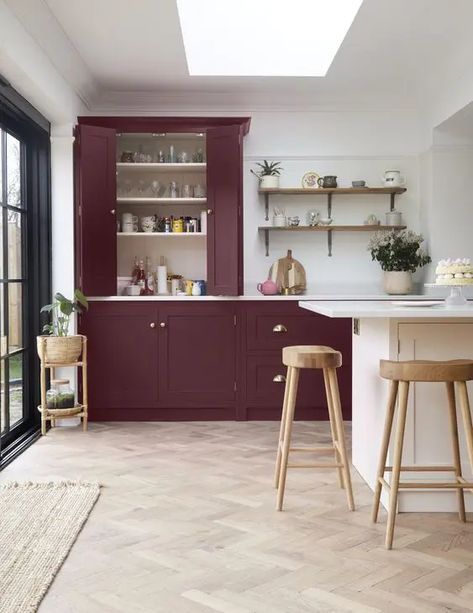 Picture of a sophisticated burgundy to purple kitchen with open shelves, a white kitchen island and wooden stools Burgundy And White Kitchen, Burgundy Kitchen Island, Burgandy Kitchen Cupboards, Burgundy Kitchen Tiles, Burgundy Kitchen, Kitchen With Open Shelves, Red Pendant Lights Over Kitchen Island, Maroon Pendant Light, Purple Kitchen