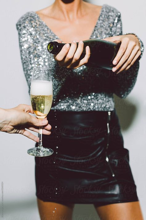 A person in a sequin top and black skirt pours champagne into a glass held by another person. Nye Party Photoshoot, Business Celebration Photoshoot, New Year’s Eve Picture Ideas, New Years Photoshoot Ideas, Champagne Photoshoot, Nye Photoshoot, Celebration Photoshoot, New Year Photography, New Years Eve Pictures