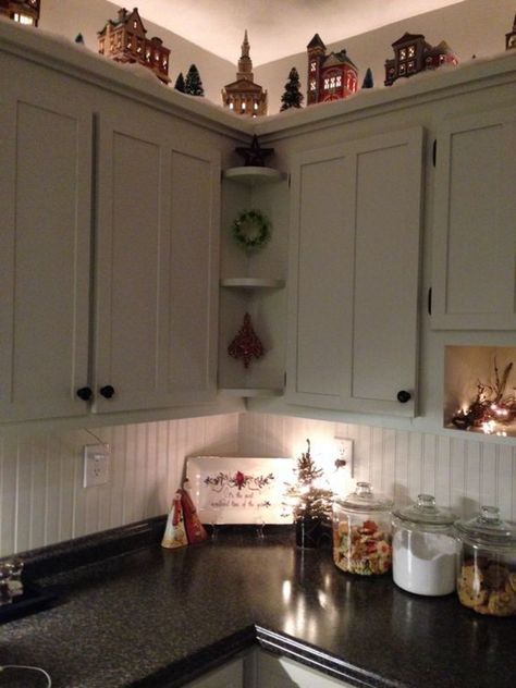 Christmas Village On Cabinets, Above Cabinet Christmas Village, Christmas Village Above Cabinets, Village Above Cabinets, Fall Garland Above Kitchen Cabinets, Garland On Top Of Cabinets, Christmas Village Kitchen Cabinets, Christmas Top Of Cabinet Decor, Christmas Decor For Above Cabinets