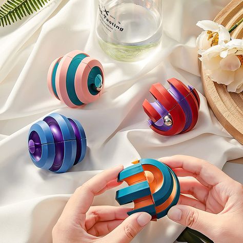 Flip, twist, roll, and rotate this orbit toy and experience the joy of spinning marbles! Tired of fidget spinners or pop-it’s? This is a fun and affordable fidget for all ages. The Rotating Orbit Fidget Cube Toy is made of high-quality eco-friendly ABS materials with a smooth, ergonomic surface. Four marbles freely move along the inside of the rotating ball and is fairly quiet with the click of the metal balls tapping each other being the only sound – the perfect boredom buster.This stress relie Perplexus Ball, Fidget Ball, Sensory Space, Stim Toys, Marble Toys, Cube Games, Cool Fidget Toys, Fidget Cube, Cube Toy