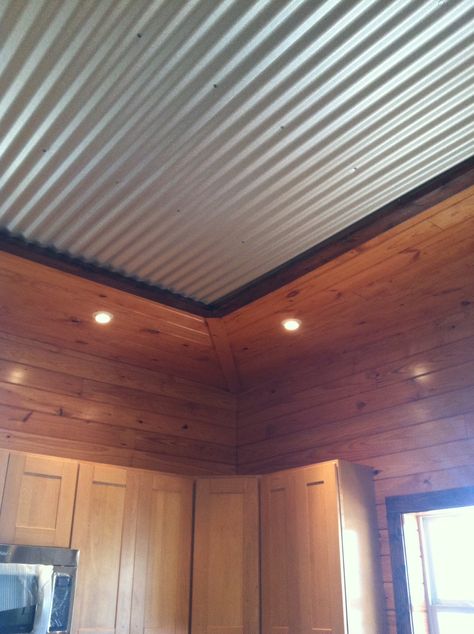 Interesting tin ceiling framed by tounge and groove pine siding on ceiling as well as on the wall and trimmed with darker wood. Tin On Ceiling, Galvanized Ceiling Ideas, Galvanized Tin Ceiling, Galvanized Metal Ceiling, Corrugated Metal Ceiling, Corrugated Tin Ceiling, Metal Panel Ceiling, Decorative Ceiling Panels, Tin Interior