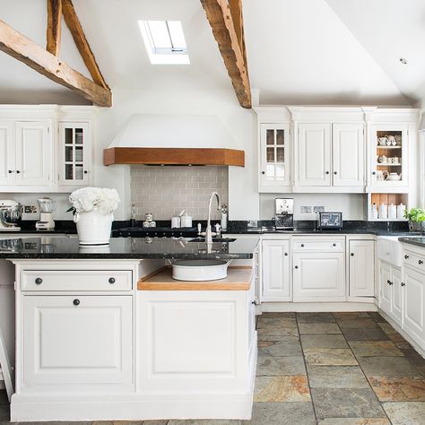 A stone floor is a lovely addition to any country kitchen. Get the effect with a limestone tile, or choose a modern lookalike in porcelain. In this modern farmhouse, classic white units give the scheme a light feel that sits comfortably with the varied tones of the flooring. Kitchen Floor Tile Patterns, Kitchen Floor Tile Design, Modern Kitchen Flooring, Kitchen Flooring Ideas, Best Flooring For Kitchen, Slate Floor, Country Kitchen Cabinets, Wood Floor Kitchen, Decor Ikea