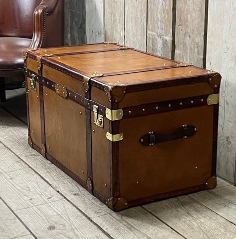 Luxury tan leather English handmade leather coffee table trunk chest Handmade tan leather with dark bridle leather hand dyed trim Beautiful tan leather chest with lined interior and large storage Luxurious interior design piece and superb coffee table bed end piece Antique Chest Trunk, Vintage Chest Trunk, Vintage Wooden Trunk, Leather Trunks Vintage, Antique Camel Back Trunk, Leather Coffee Table, Dark Trim, Leather Trunk, Bed End