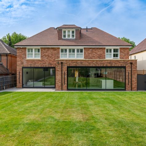 Our client wanted a modern look to the back of this luxurious new build, so two sets of sliding doors were the perfect option. As with all of our products, the size and style is completely bespoke and unique for your home. For this project, the panels of the sliding doors are wider in the kitchen area, with narrower panels in the living area where the opening is smaller. The ultra slim profiles look wonderful, with maximum glass and minimum frames allowing the light to flood the home! Slim Frame Sliding Doors, Ultra Slim Sliding Doors, Sliding Exterior Doors, Double Sliding Patio Doors, Patio Sliding Door, Timber Front Door, Sliding Doors Internal, Kitchen Extensions, Sliding Doors Exterior