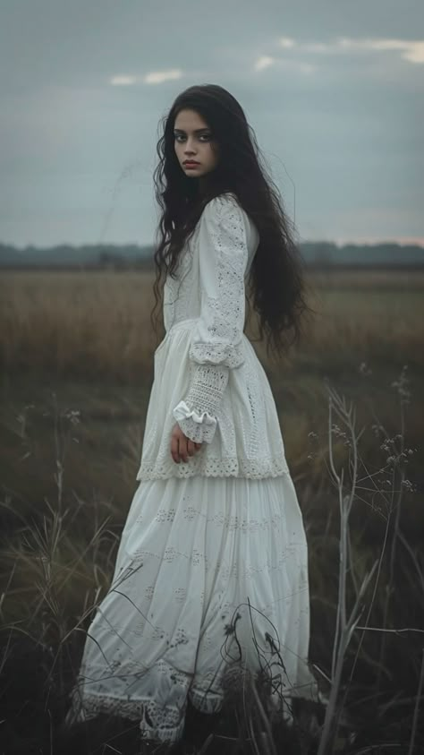 girl in white dress, standing in the field on edge, in the style of dark and spooky themes, flowing fabrics, dollcore, webcam photography, witchcore, candid shots of famous figures, haunting images Witchy Field Photoshoot, Gothic Photography Aesthetic, Witch Poses Reference Photo, Woman In White Ghost, Flowing Dress Photography, Female Standing Reference, Southern Gothic Photoshoot, Spooky Pose Reference, Witch Pose