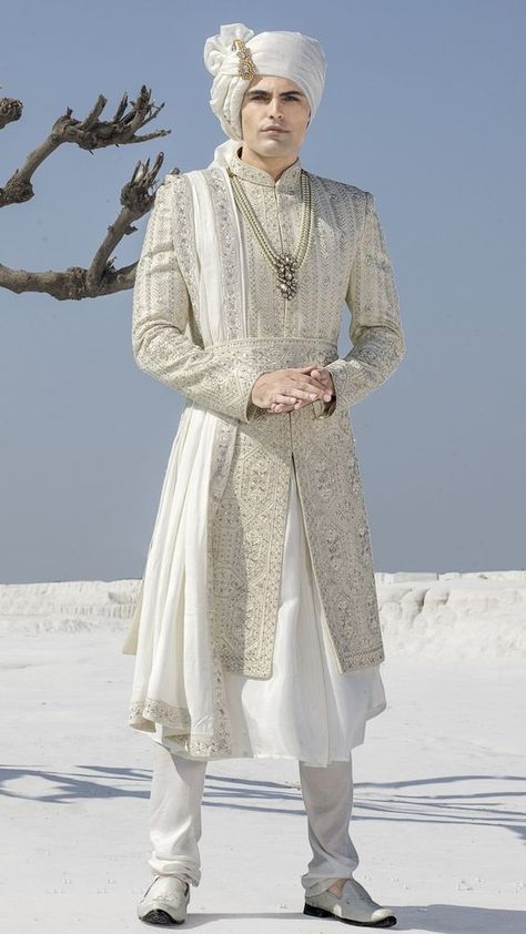 Introducing a white sherwani with thread embroidery work that is layered with a matching plain anarkali kurta and a beautifully designed waist belt. Paired with a white color dupatta and a matching churidar. Shop White Wedding Sherwani For Groom Online at Tathastu. Shipping Worldwide. Phera Outfit For Groom, Anarkali Sherwani Men, Shervani Design For Men, Wedding Dress For Groom, Plain Anarkali, Wedding Sherwani For Groom, Groom Indian Wedding Outfits, White Sherwani, Sherwani For Groom