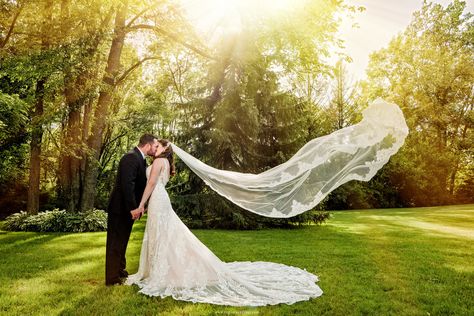 A long wedding dress veil flies in the air as the bride kisses her groom. Flying Veil Wedding Photos, Long Veil Wedding Photos, Indoor Church Wedding, Long Distance Wedding, Wedding Photo Board, Winter Mountain Wedding, Valparaiso Indiana, Wedding Styling Ideas, Backyard Wedding Ceremony