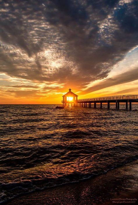 The sunset is photographed in this captivating shot from Lake Pontchartrain.  Louisiana Mandeville Louisiana, Nifty 50, Pier House, Louisiana Bayou, Lake Pontchartrain, Sunset Point, Sunrise Photos, Gorgeous Places, Sea To Shining Sea