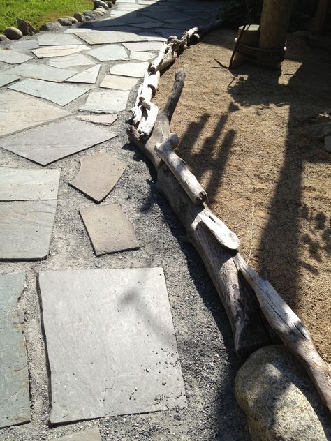 Driftwood pieces used for a landscape bed border. I will eventually secure them together. Driftwood Garden Border, Driftwood Landscaping, Driftwood Landscaping Ideas, Riverbed Landscaping, Dry Riverbed Landscaping, Driftwood Garden, Wooded Backyard, Cottage Makeover, Rock Landscaping Ideas