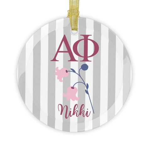 "Alpha Phi sorority christmas ornament  Create stunning decorations with your art on these blank glass ornaments. All ornaments are 100% clear glass, one size (3.5\"/ 88.9mm), come with beveled edges and a gold ribbon for that extra flair.  N.B. The design might appear slightly transparent and grainy on the final product. Darker and more saturated colors are recommended for best results. .: Material: 100% clear glass .: One size: 3.5\" (88.9mm) .: Beveled edges .: One-sided print .: Comes with a gold ribbon for hanging" Sorority Christmas, Alpha Phi Sorority, Alpha Phi, Sorority Gifts, Gold Ribbon, Gold Ribbons, Saturated Color, Beveled Edge, One Sided