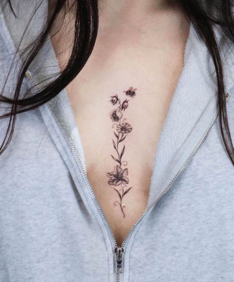 48 Unique Bee Tattoos with Meaning - Our Mindful Life Bee Sternum Tattoo Women, Bee Chest Tattoo, Breastbone Tattoos For Women, Bee Sternum Tattoo, Unique Pretty Tattoos Beautiful, Tattoos In Between Breast, Flower Chest Tattoo Female, Cleavage Tattoos For Women, Center Chest Tattoo Female