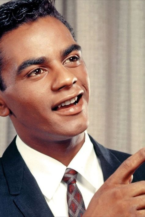 September 30, 1935: Johnny Mathis is born John Royce Mathis in Gilmer, Texas. He is raised in San Francisco. A star athlete, he turns down the chance to try out for the US Olympic Team as a high jumper in 1954 to pursue a career in music. Swooning hits like "Chances Are," "The Twelfth Of Never," "Misty," and "Wonderful! Wonderful!" earn him the title of the king of makeout music in the '50s and '60s, and a string of popular Christmas albums make him a radio favorite each holiday season. Gilmer Texas, Cuban Missile Crisis, Johnny Mathis, Harry Belafonte, Rock And, Us Olympics, Christmas Albums, Olympic Team, Man On The Moon