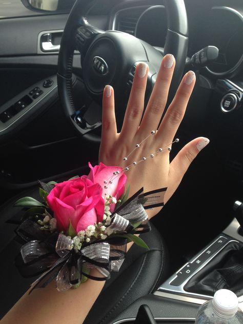 Corsage Pink And Black, Prom Crossage Ideas Pink, Pink Wrist Corsage Homecoming, Black Prom Dress With Pink Accessories, Corsage To Go With Black Dress, Pink Prom Theme, Hot Pink And Black Corsage Prom, Prom Flower Ideas, Pink Bouquet And Boutonniere