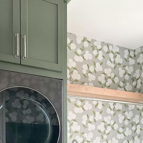 Britney Fedricks on Instagram: "Laundry Rooms should not only be functional, but fun! Stacking the washer and dryer gave us extra countertop space for folding at our Carrollton project 🧺 And this @riflepaperco wallpaper paired with the green cabinets… yes please 🙋🏻‍♀️  - #laundryroom #laundryroomgoals #lgappliances #lifesgood #riflepaperco #wallpaper  Green Cabinets, Laundry Room, Stacked Washer Dryer, Gray Floor Tile, Floral Wallpaper" Green Cabinets In Laundry Room, Laundry Room Makeover Wallpaper, Green Cabinets Laundry, Riflepaperco Wallpaper, Laundry Room Stacked, Green Cabinets Laundry Room, Laundry Room With Wallpaper, Wallpaper In Laundry Room, Cabinets Laundry Room