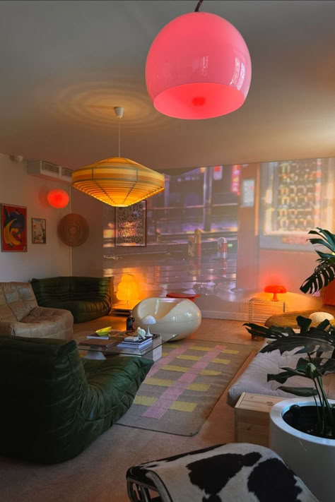 Dive into this vibrant and eclectic living room, where vintage charm meets modern flair. The mix of colourful lighting, retro furniture, and unique decor pieces create a playful yet cosy atmosphere. Perfect for those who love bold statements and a touch of nostalgia in their home decor. Explore Vinterior's living room edit and find your perfect piece. Image via goodeyesthetics. Funky Interior Design, Retro Aesthetic Room, Funky Eclectic Decor, Colourful Lighting, Funky Living Room, Eclectic Decor Vintage, Vibey Apartment, Funky Room, Vintage Living Room Furniture