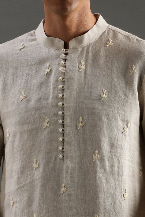 Beige linen kurta with pearl hand embroidered placket and motifs. Comes with off-white pyjama. Components: 2 Pattern: Hand embroidered Type Of Work: Pearl Neckline: Band collar Sleeve Type: Full Fabric: Linen Color: Beige Other Details:  Closure : Front buttons Occasion: Mehendi and Puja,Sangeet - Aza Fashions White Kurta Pattern For Men, Hand Embroidery Designs For Mens Kurta, Menswear Kurta Designs, Indian Wedding Kurta For Men, Kurta Pattern For Men, Kurta Buttons Mens, Kurta Collar Designs For Men, Kurta Work Designs For Men, Panjabi Embroidery Design For Men