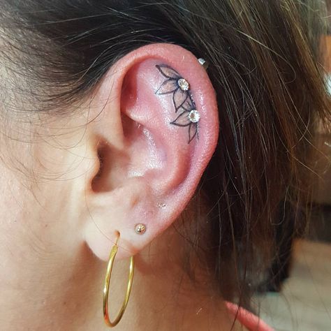 It was quite the project to work 2 little flowers in with a couple of existing piercings. But they came out so cute ♡ #tattoos #tattoo… | Instagram Ear Tattoo With Piercing Flowers, Small Tattoo By Ear, Flower In Ear Tattoo, Ear Tattoo Inner With Piercing, Ear Flower Tattoo With Piercing, Ear Piercing And Tattoo, Flower Ear Tattoo With Piercing, Inside Ear Tattoos Flower, Tattoos In Front Of Ear