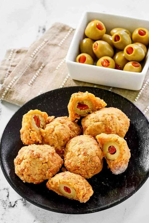 Delight your guests with these savory Olive Cheese Balls! Pimento stuffed green olives are wrapped in a buttery cheddar dough and then baked to golden perfection. A perfect make-ahead appetizer, these classic bites are sure to impress at any gathering. Get the easy recipe and find out how to make the best olive cheese balls. Olive Cheese Balls Appetizers, Olive Cheese Ball Recipes, Olive Cheese Balls, Cheese Olives Appetizer, Olive Balls, Cheese Dough, Olive Appetizer, Make Ahead Appetizers, Olive Recipes