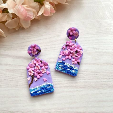 Purple sakura earrings. Last pair left. Probably retiring this design. I always like to try new designs 😆 Sakura Earrings, Purple Sakura, Asian Aesthetic, Clay Artist, Purple Earrings, Clay Ideas, Artist On Instagram, Polymer Clay Crafts, New Designs