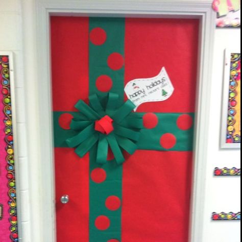 Gift wrapped door  #preschool #prek #bulletinboards #winter #classroomdoor #christmas Easy Door Decorations Classroom Holidays, Present Door Decoration Christmas, Christmas Gift Door Decoration, Simple Christmas Door Decorating Contest, Gift Wrap Door Decoration, Christmas Present Door Decoration, Door Present Decoration, Gift Wrapped Door, Christmas Door Display