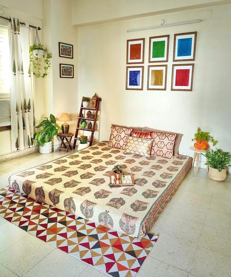 A stylish and cozy mattress with a beautiful design has been placed in the center of this living room, providing a cozy spot for relaxation, lounging, or even socializing. A side table has been placed on both sides of the mattress to enhance the functionality and aesthetics of the seating space. The sheer fabric of the curtains create a soft and ethereal ambiance, diffusing the light and adding a touch of elegance to the space. Cr: mycradleofdreams Mattress On Floor Ideas Living Room, Urban Ladder, Seating Ideas, Mattress On Floor, Cozy Seating, Cozy Spot, Contemporary Floor, Bedroom Decor Design, Floor Seating