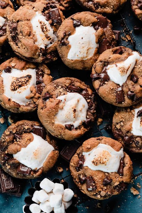 S'mores Cookies are thick & chewy bakery-style cookies full of graham cracker crumbs. hershey bar pieces, and chocolate chips. They're each stuffed with a marshmallow and rolled in graham crumbs, then baked to gooey perfection! It's all the nostalgia of s'mores - with no campfire required! Jumbo Smores Cookies, Levain Smores Cookies, Best Smores Cookies, Chocolate Chip Smores Cookies, Peanut Butter Smores Cookies, S'mores Cookies Recipe, S’mores Cookie, Smores Blondies, Summer Bakes