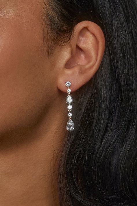 These classic, timeless earrings feature a knife edge connection technique and mixed cut pear and round stones for maximum sparkle. Upgrade any outfit with these elegant, linear earrings. Dangly Sparkly Earrings, Prom Inspo Jewelry, Silver Jewelry Formal, Silver Wedding Earrings, Silver Jewelry Prom, Prom Necessities, Middle School Prom, Planterra Wedding, Silver Earrings Prom