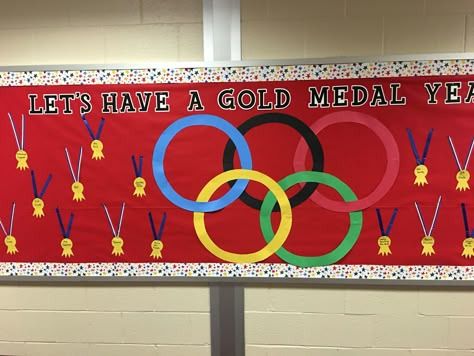 Olympic themed bulletin board Olympic Board Ideas, P.e. Bulletin Board Ideas, Back To School Olympics Bulletin Board, Olympic Bulletin Boards For School, Olympic Decorations Classroom, Olympic Theme Classroom Door, Olympics Display Classroom, Olympic Theme Classroom Bulletin Boards, Science Vocabulary Parade