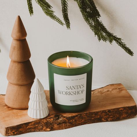 Step into the enchanting world of the North Pole with our Santa's Workshop candle. Infused with the delightful scents of bayberry, clove, nutmeg, and cedar, this candle captures the magical atmosphere of Santa's bustling workshop. Imagine the warm, spicy aromas mingling with the fresh, woody notes, evoking the excitement and wonder of holiday preparations. Fragrance Notes Top: Bayberry Middle: Clove, Nutmeg, Ginger Base: Cypress, Cedar, Balsam, Fir, Musk Candle Care For the longest, safest burn, Window Frame Ideas, Musk Candle, Fresh Cut Christmas Trees, Christmas Tree Base, Ig Post Ideas, Revolving Door, Vanilla Candle, Candle Care, Santa's Workshop