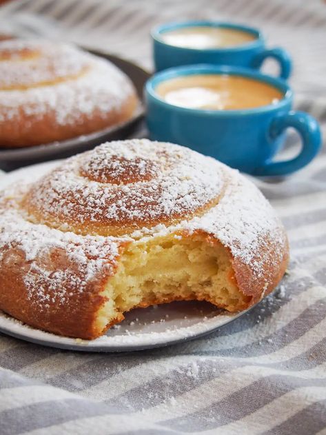 Pan de Mallorca are an egg-rich but light-textured, gently sweet bread roll from Puerto Rico. They're easy to recognize, coiled up and dusted with sugar, and make a delicious breakfast or snack. - roll with bite Mallorca Bread, Orange Sweet Rolls, Sweet Bread Rolls, Cinnamon Breakfast, Puerto Rico Food, Boricua Recipes, Hawaiian Sweet Rolls, Bread Roll, Sweet Rolls