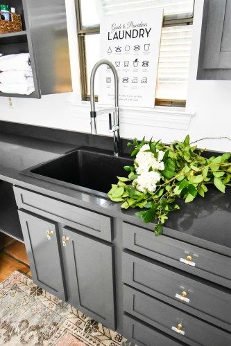 A laundry room sink, also called a utility sink or laundry sink, can be a major convenience if you have the space for one in your home. Read on to see the laundry room sink I chose for our new laundry room and why I love it! #laundryroom #laundryroomsink #utilitysink #utilityroom #laundry #wayfair #blanco #blacksink Utility Sink With Counter, Laundry Room Tub Sink, Black Utility Sink In Laundry Room, Utility Sink Faucet, Deep Laundry Sink, Laundry Sinks Utility, Laundry Room Faucets Utility Sink, Farm Sink Laundry Room, Laundry Room With Sink In The Middle