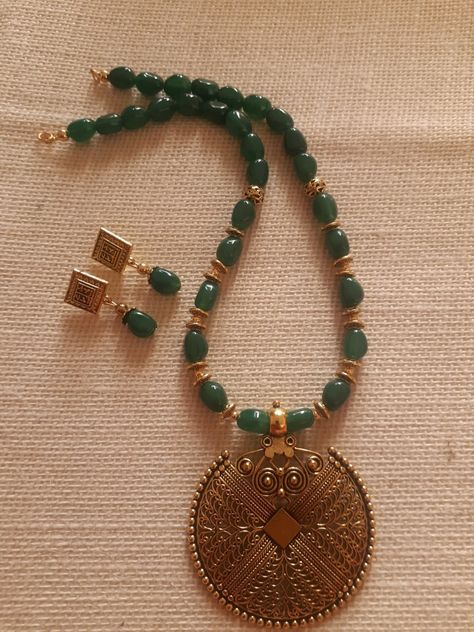 Green bead with oxidised gold pendant jewellery set.  Pls whatsapp 9344577187 for more details Jewellery Patterns, Reunion Outfit, Gold Statement Jewelry, Ruby Jewelry Necklaces, Desi Jewelry, Simple Beaded Necklaces, Cutwork Blouse, Kundan Jewellery Set, Elegant Jewellery