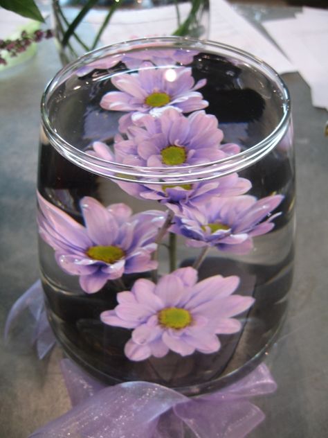 Submerged Flowers are a great idea for showcasing a single flower or just a few...  Arrange the Flowers in a Flower Frog to 'weigh' them down..  Use a Chrysal CBVn Tablet to help keep the water clear...  Top off the VASE when it's in it's final location... to prevent spills! Learn how to do this: http://www.youtube.com/watch?v=B--Y0pzph5A Diy Small Flower Arrangements, Submerged Flower Centerpiece, Submerged Flowers, Glass Vase Wedding Centerpieces, Bud Vases Arrangements, Short Centerpieces, Glass Vases Wedding, Flower Arranging Tutorial, Flower Projects