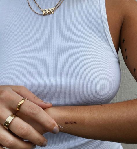 Jessica Olie Tattoo, Fred Again Tattoo Ideas, Fine Line Roman Numeral Tattoo Arm, Tiny Side Tattoo, Small Inner Elbow Tattoo, Small Metal Health Tattoos, 714 Tattoo, Minimalist Initial Tattoo, Wrist Tatoos Woman