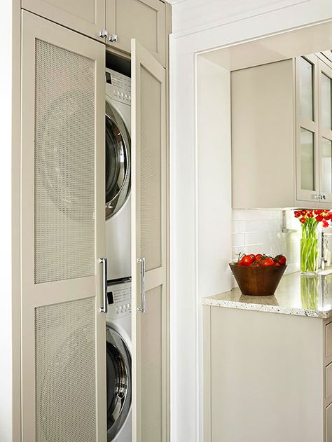 Small-Space Laundry Closet A full-size laundry room might not be an option for some condos, apartments, and small homes. This stacked washer and dryer tucks away in a slim closet off of the kitchen and uses nearby cabinets for storage. Perforated door panels add visual interest and ventilate the laundry area while keeping the appliances out of sight. Laundry Room Storage Solutions, Laundry Storage Solutions, Laundry Room Storage Shelves, Small Laundry Room Organization, Laundry Room Doors, Laundry Decor, Laundry Closet, Small Laundry Rooms, Small Laundry Room