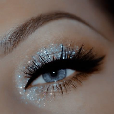 Glittery Black Eyeshadow, New Year’s Eve Makeup Glitter, Cute Makeup Looks For Homecoming, Silver Eyeliner Ideas, Grey Eyeshadow Looks Blue Eyes, Makeup Looks For A Silver Dress, Eyeshadow Ideas For White Dress, Silver Eye Makeup With Rhinestones, Prom Makeup Looks For Black Dress Blue Eyes