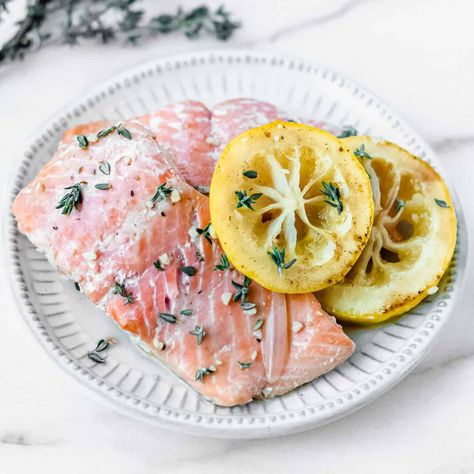 Poached Salmon with Lemon Garlic Butter Sauce - Delicious Little Bites Butter Poached Salmon, Salmon Lemon Butter Sauce, Salmon With Garlic Lemon Butter Sauce, Salmon Lemon Butter, Olive Oil Poached Salmon, Lemon Garlic Butter Sauce, Salmon With Lemon, Poached Salmon, Lemon Salmon